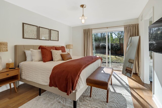 bedroom featuring light wood-type flooring and access to exterior