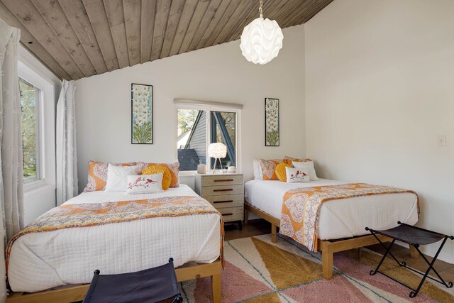 bedroom featuring wood ceiling, vaulted ceiling, and hardwood / wood-style floors