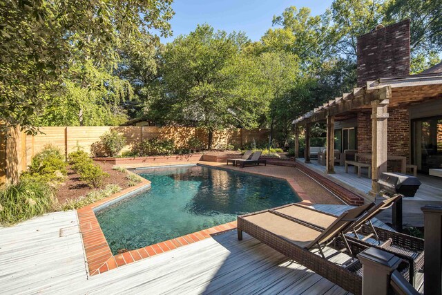 view of swimming pool with a wooden deck and a patio