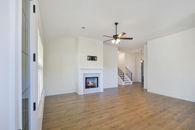 unfurnished living room featuring hardwood / wood-style flooring and ceiling fan