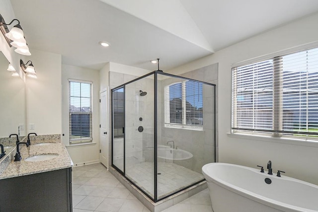 bathroom with vanity, shower with separate bathtub, lofted ceiling, and tile patterned floors