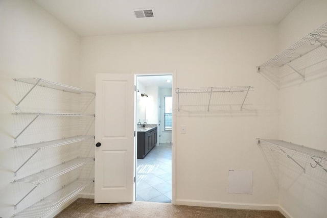 spacious closet featuring tile patterned floors