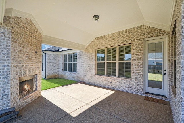 view of patio featuring an outdoor brick fireplace