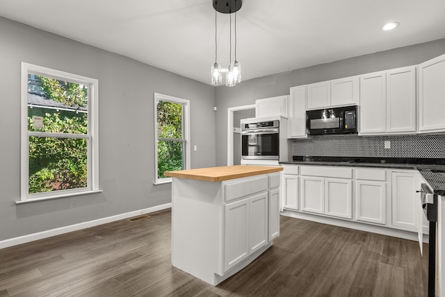 kitchen with white cabinetry, black appliances, pendant lighting, and a wealth of natural light