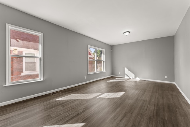 empty room featuring dark hardwood / wood-style flooring