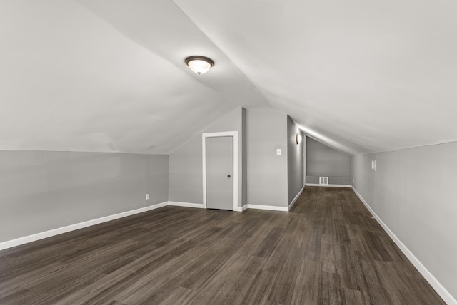 bonus room featuring lofted ceiling and dark wood-type flooring