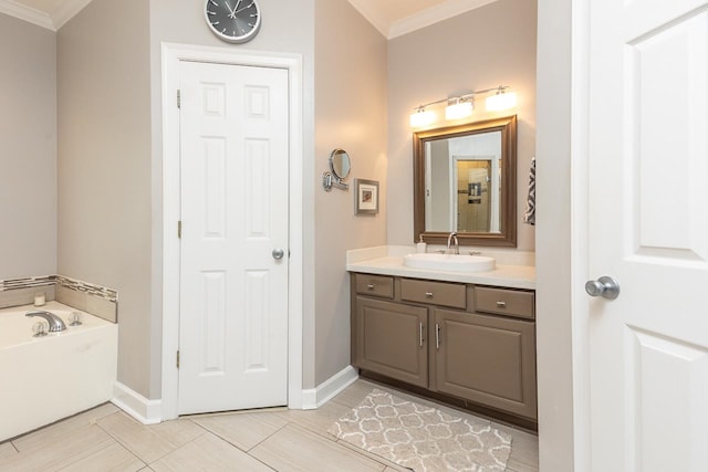 bathroom featuring vanity, crown molding, and a bathtub