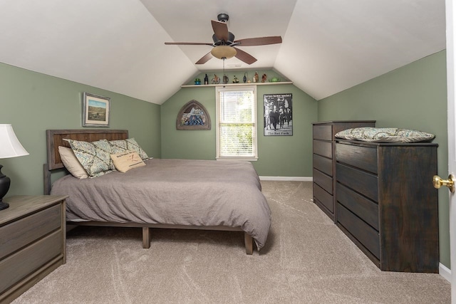 bedroom featuring ceiling fan, vaulted ceiling, and light colored carpet