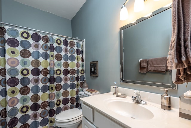 bathroom with vanity, a shower with shower curtain, and toilet