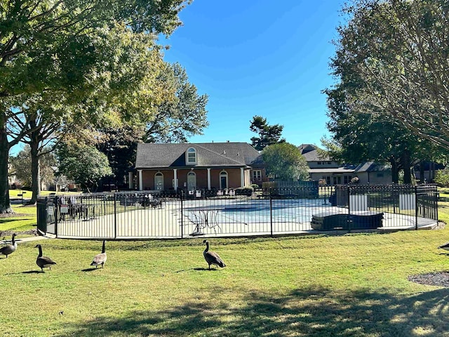 view of pool featuring a yard