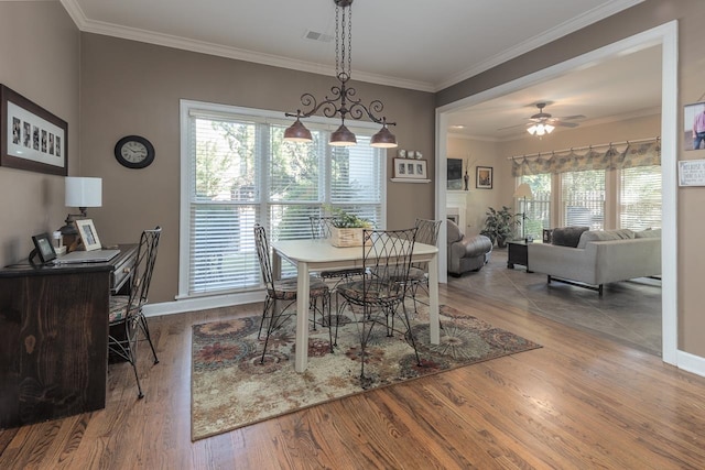 dining area with crown molding, wood-type flooring, plenty of natural light, and ceiling fan