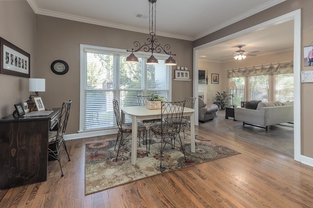 1842 Swynford Ln, Collierville, TN 38017 - dining space with ornamental molding, a ceiling fan, wood finished floors, and baseboards