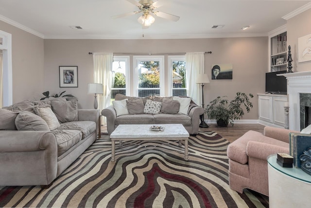 1842 Swynford Ln, Collierville, TN 38017 - living room featuring visible vents, a premium fireplace, ornamental molding, wood finished floors, and a ceiling fan
