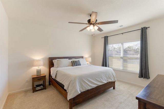 bedroom featuring light carpet and ceiling fan