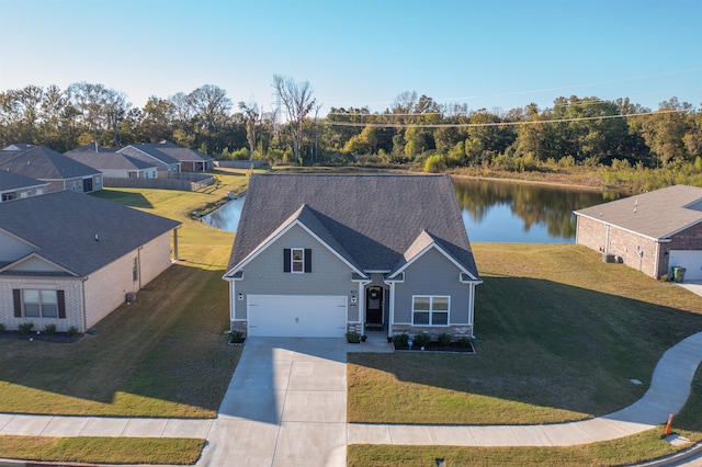 view of front of house featuring a water view, a front yard, and a garage