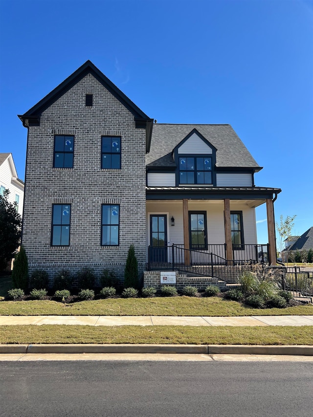 view of front of home featuring a front lawn and covered porch