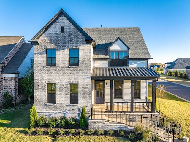 300 Mary Taylor Way, Piperton, TN 38017 - view of front of house featuring covered porch, brick siding, a front lawn, and a standing seam roof