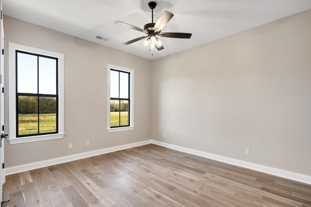 spare room featuring light hardwood / wood-style floors and ceiling fan