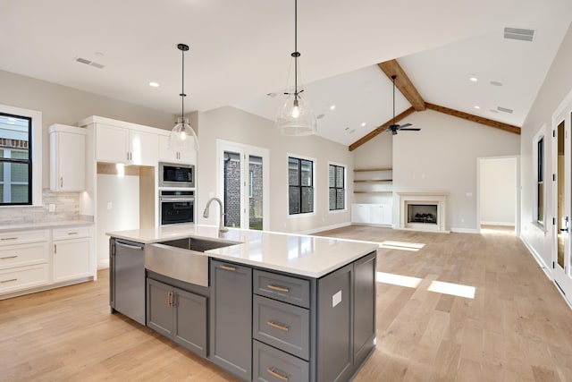 kitchen with white cabinets, stainless steel appliances, a wealth of natural light, and sink