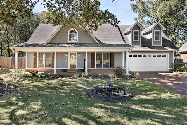 view of front facade featuring covered porch, a front lawn, and a garage