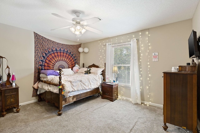 carpeted bedroom with ceiling fan and a textured ceiling