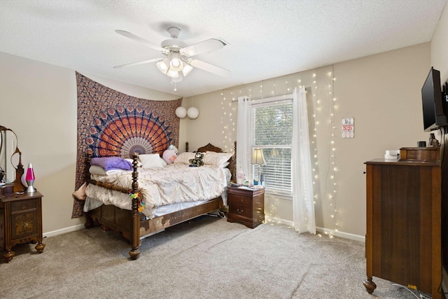 bedroom featuring carpet floors, a ceiling fan, a textured ceiling, and baseboards