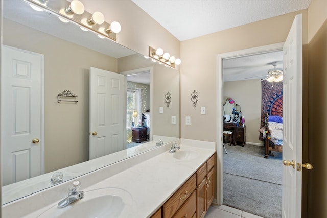 bathroom featuring vanity, a textured ceiling, tile patterned floors, and ceiling fan