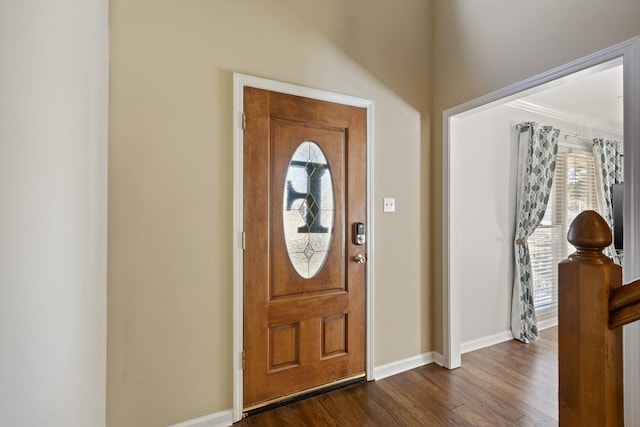 foyer entrance featuring ornamental molding and dark hardwood / wood-style floors