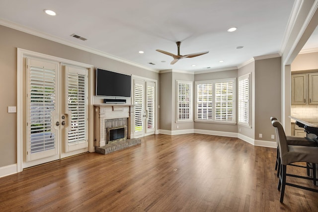 living room featuring ornamental molding, dark hardwood / wood-style flooring, and a fireplace