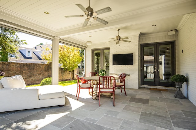 sunroom featuring french doors and ceiling fan