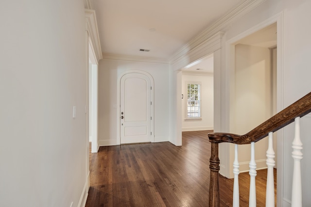 foyer featuring dark wood-type flooring and crown molding