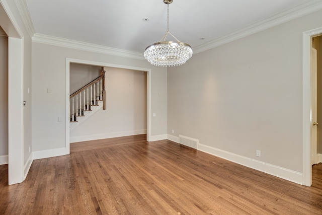 interior space with ornamental molding, hardwood / wood-style floors, and a chandelier