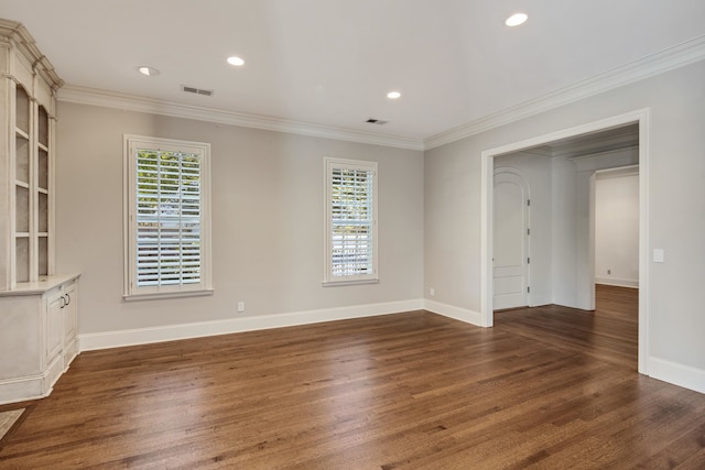 spare room with dark wood-type flooring and crown molding