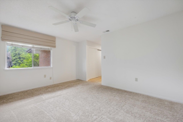 empty room featuring light carpet and ceiling fan