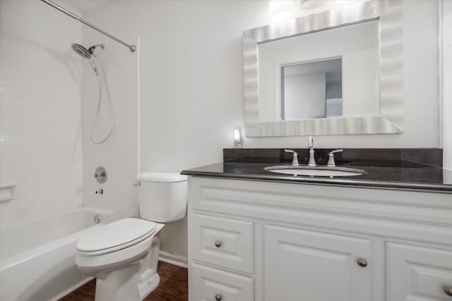 full bathroom with tiled shower / bath, vanity, hardwood / wood-style flooring, and toilet