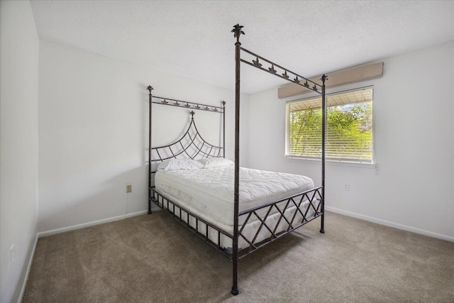 carpeted bedroom with a textured ceiling