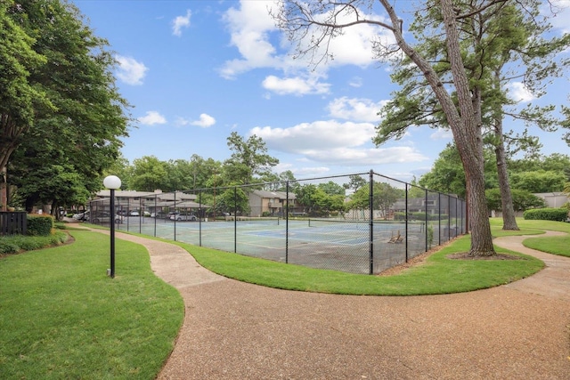 view of sport court featuring a yard