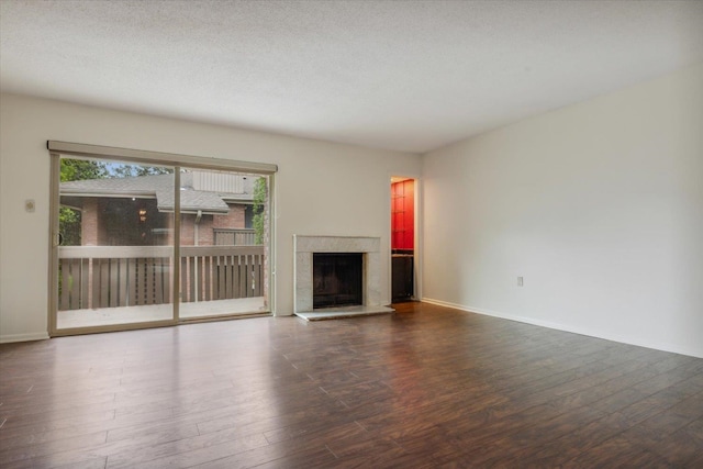 unfurnished living room with a textured ceiling and wood-type flooring