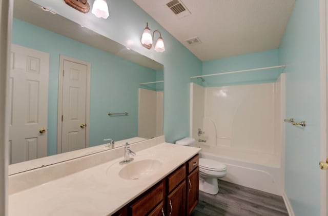 full bathroom featuring vanity, wood-type flooring, toilet, and shower / bathtub combination