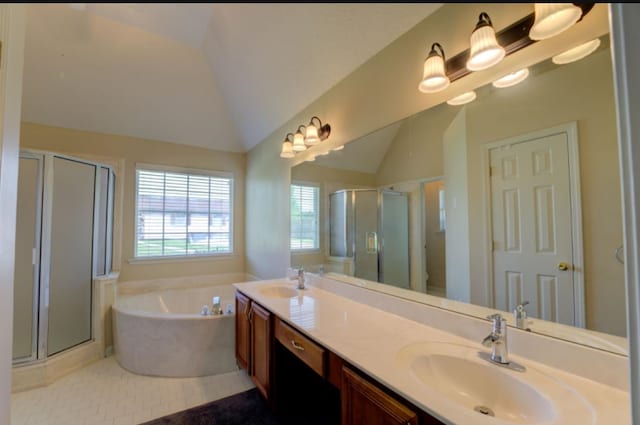 bathroom with vanity, lofted ceiling, separate shower and tub, and tile patterned floors