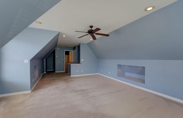 additional living space featuring ceiling fan, carpet flooring, and lofted ceiling