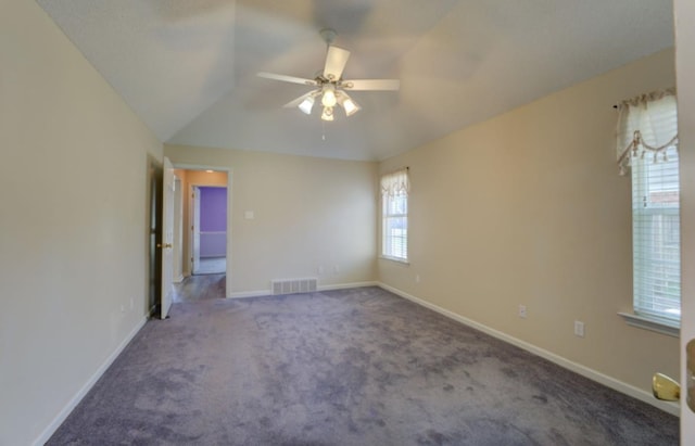 spare room featuring vaulted ceiling, carpet, and ceiling fan