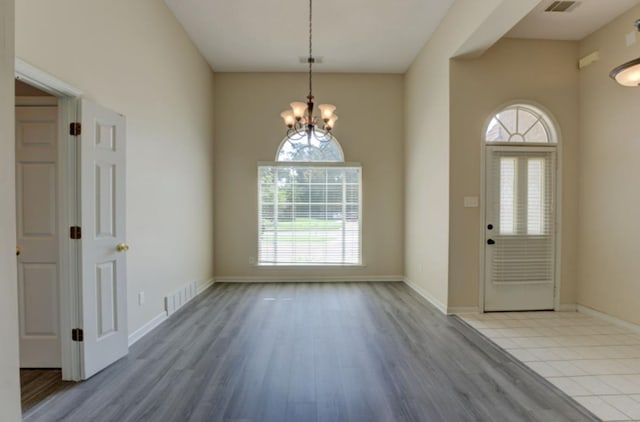 interior space with light hardwood / wood-style flooring and a chandelier