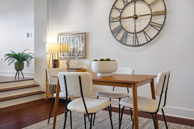 dining space with hardwood / wood-style flooring