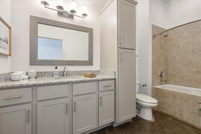 full bathroom with vanity, tiled shower / bath, and toilet