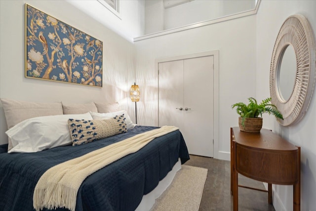 bedroom with a closet and a towering ceiling