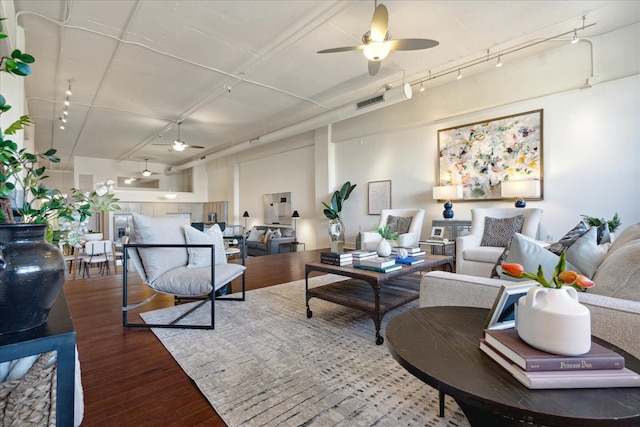 living room with hardwood / wood-style flooring, rail lighting, and ceiling fan