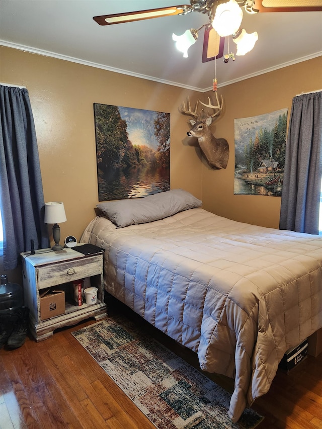 bedroom with crown molding, ceiling fan, and hardwood / wood-style flooring