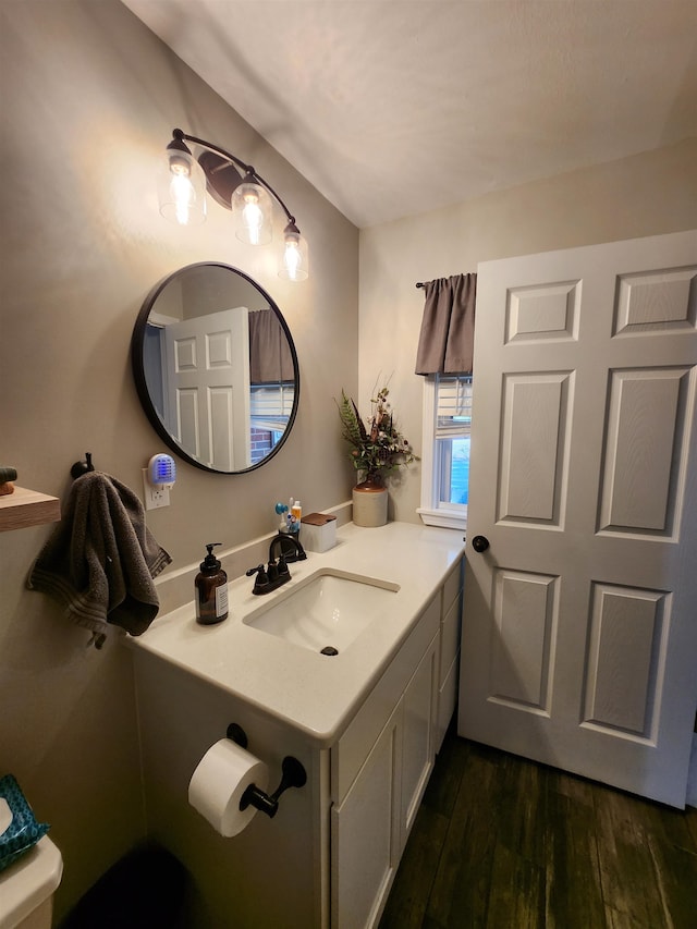 bathroom with vanity, hardwood / wood-style flooring, and toilet