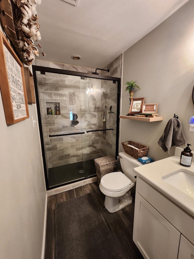 981 Durhamville Rd, Ripley, TN 38063 - full bathroom with vanity, a stall shower, wood finished floors, and toilet